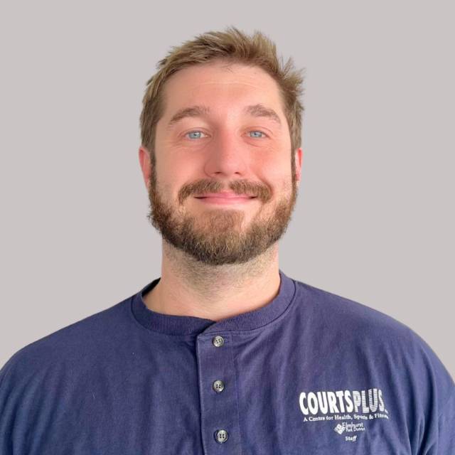 Profile photo of man smiling at camera with shirt that says Courts Plus.