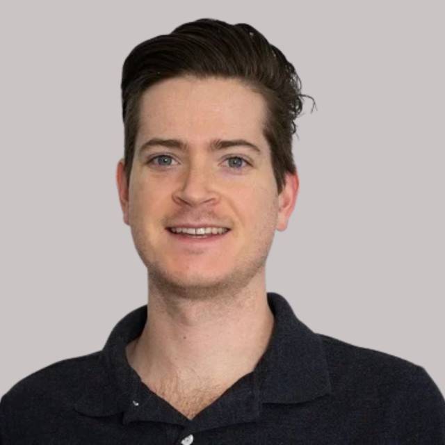 Profile photo of man smiling at camera. 